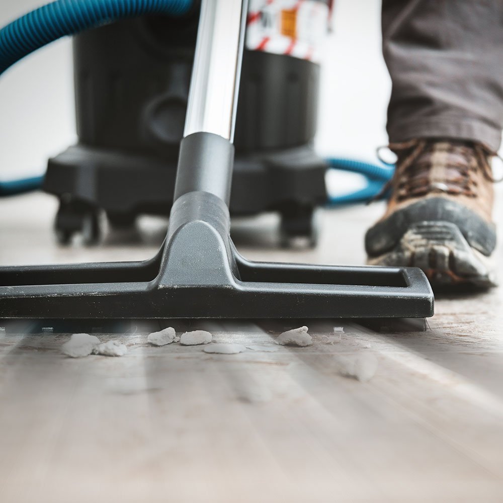 Cleaning crew performing post construction cleaning in a newly remodeled kitchen before occupancy